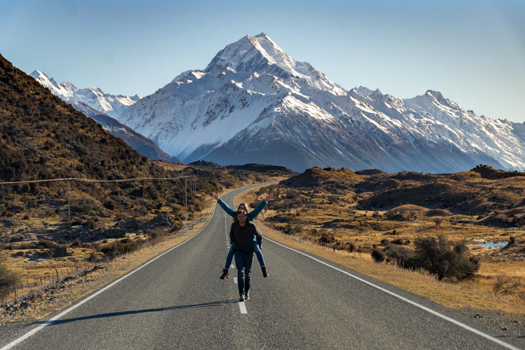 couple posing for the camera on the road to Mount Cook