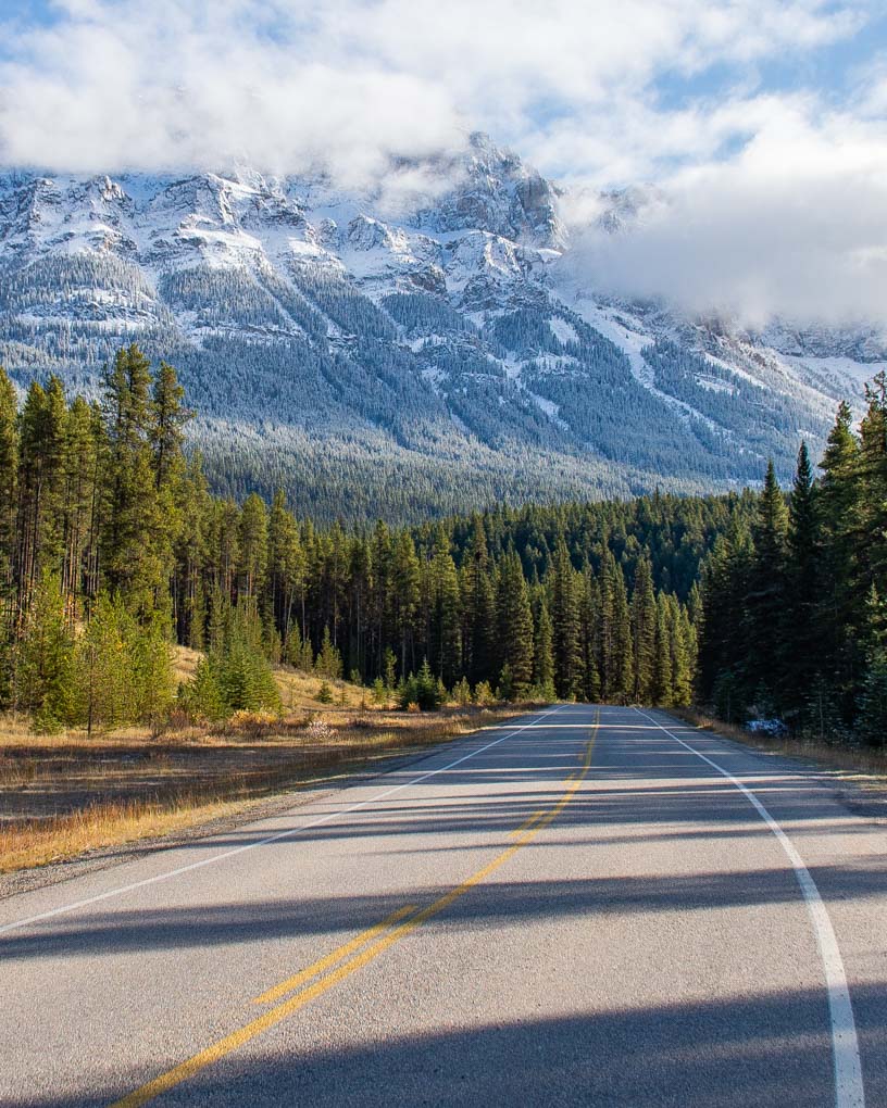A view of the road with mountains in the background on the Bow Valley Parkway in Banff National Park