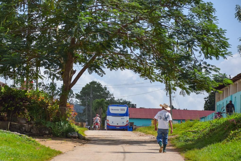 A man walks down a street in Viñales, Cuba