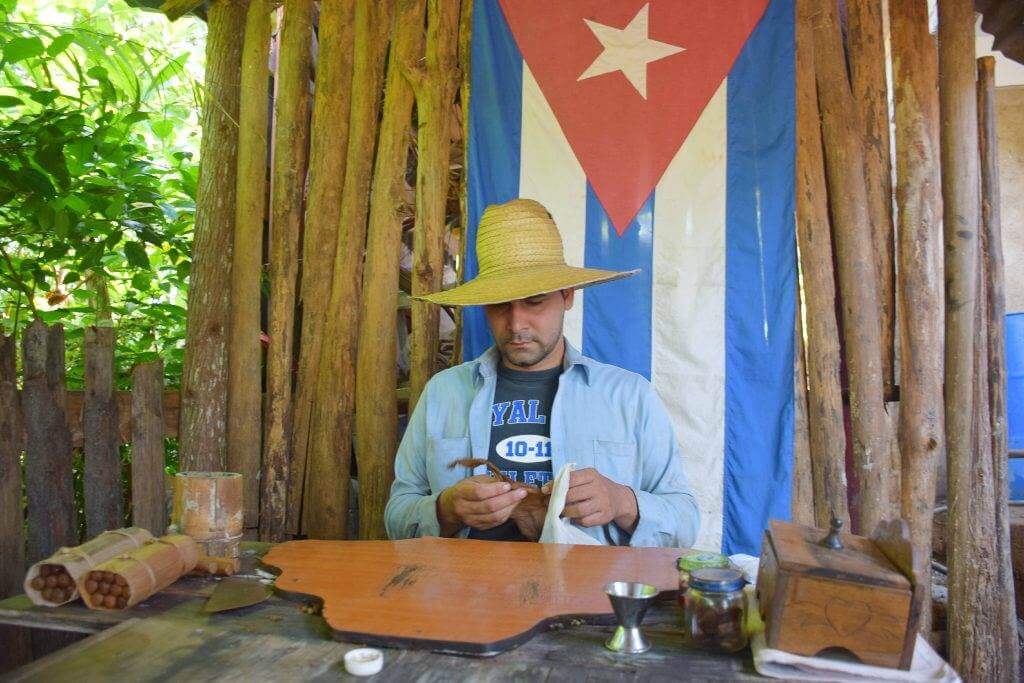 a cuban doing a cigar rolling demonstration in vinales cuba