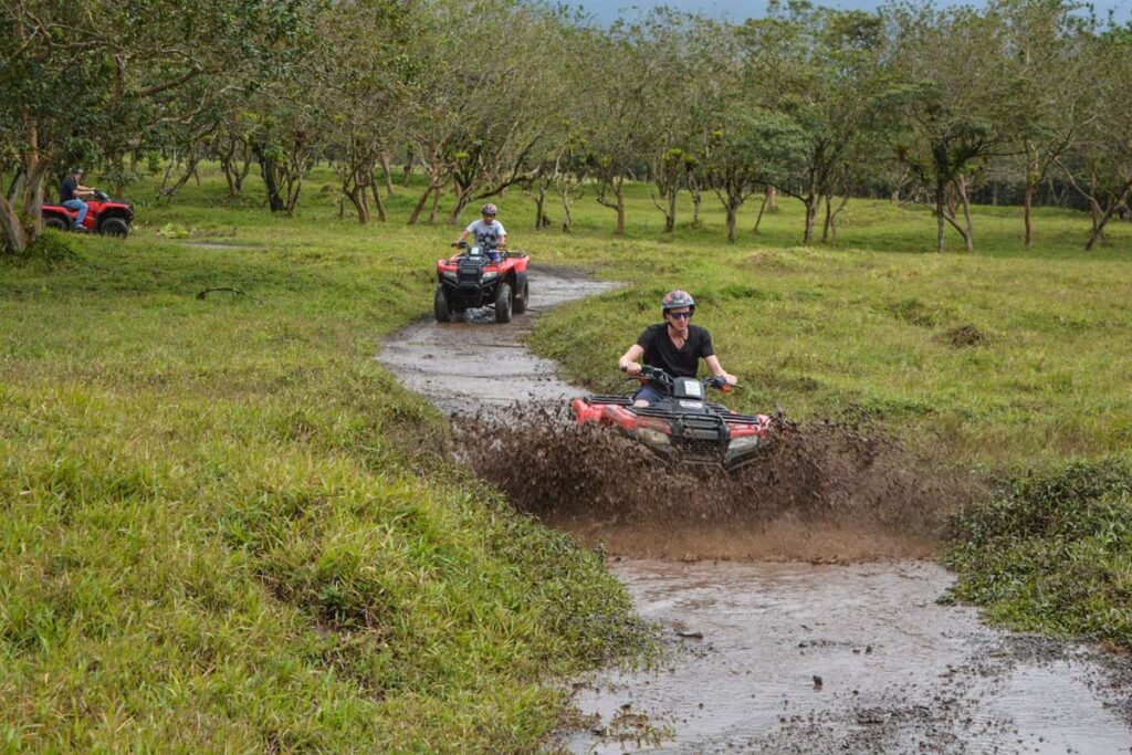 Two ATV's ride through mud in La Fortuna, Costa Rica
