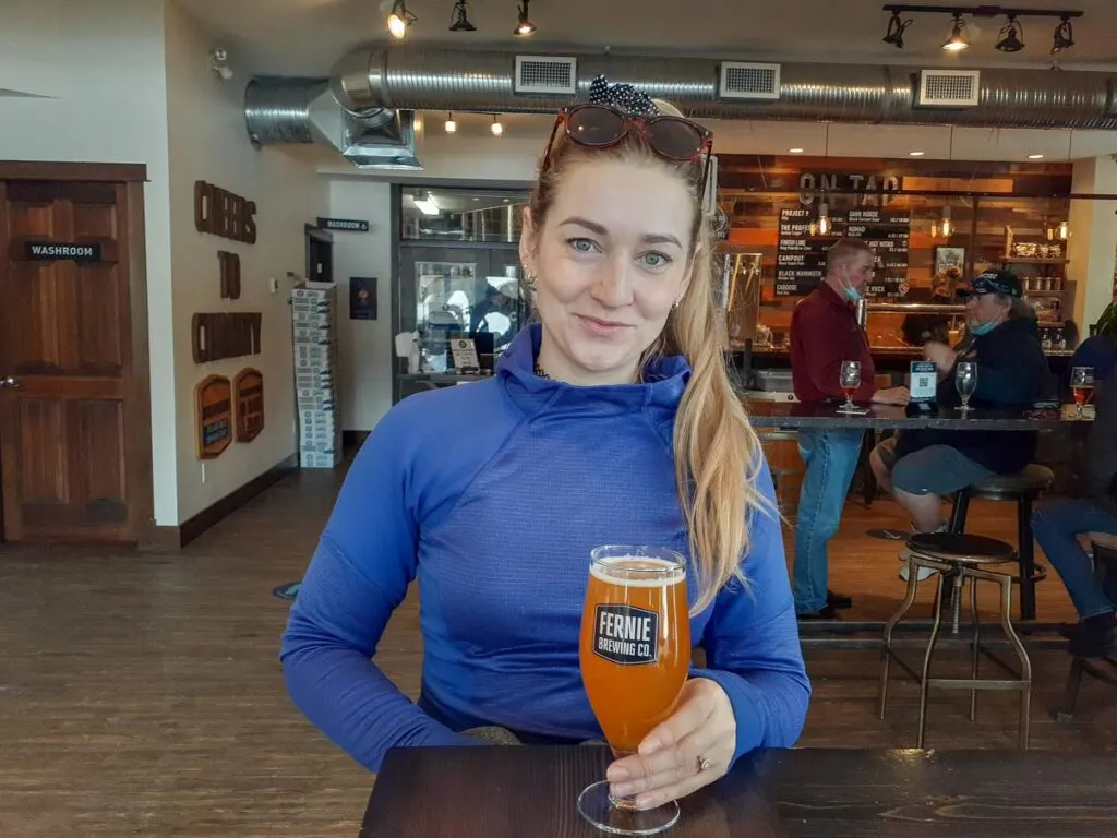 A lady has a beer at Fernie Brewing Co.