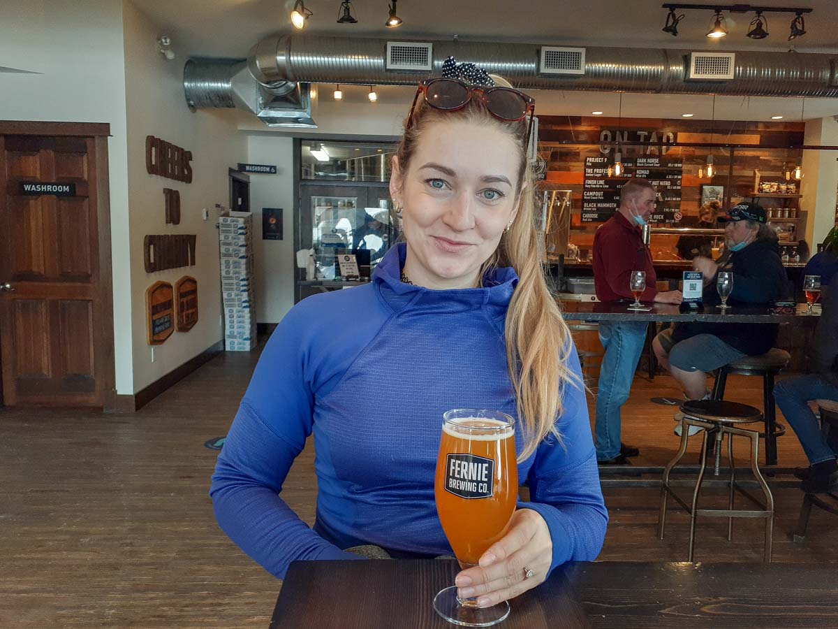 A lady has a beer at Fernie Brewing Co.