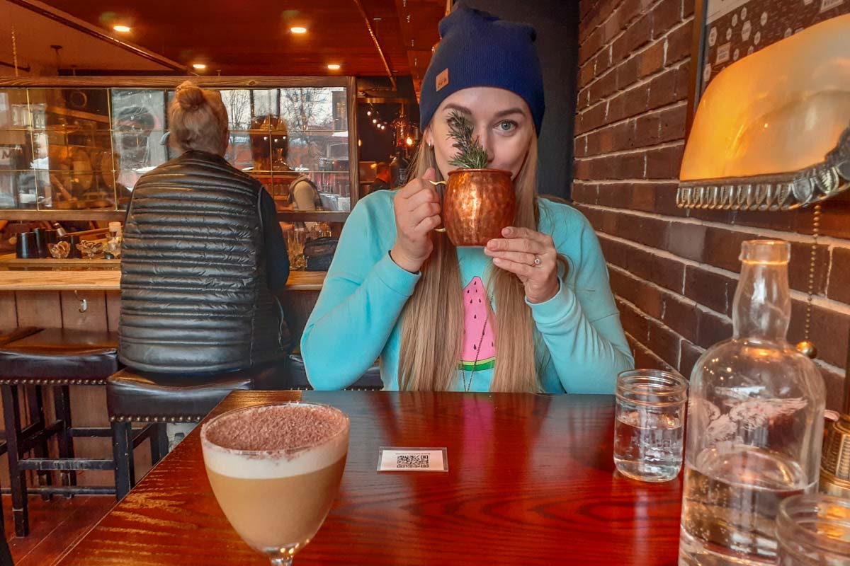 drinking a cocktail at Monashee Spirits, Revelstoke