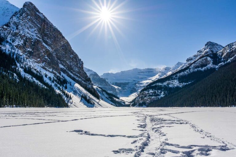 A frozen Lake Louise with mountain views in winter