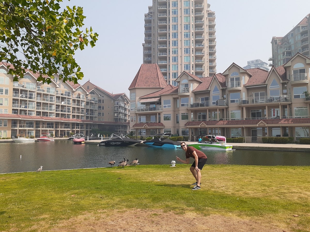man poses infront of a marina Hotel in Kelowna