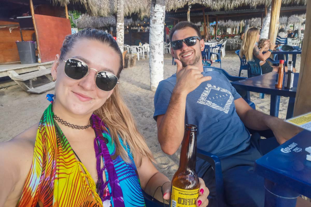Bailey and Daniel from Destinationless Travel at the beach in Sayulita