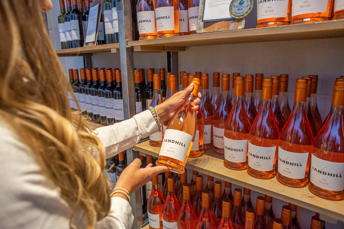 Choosing a bottle of wine at Sandhill Wines
