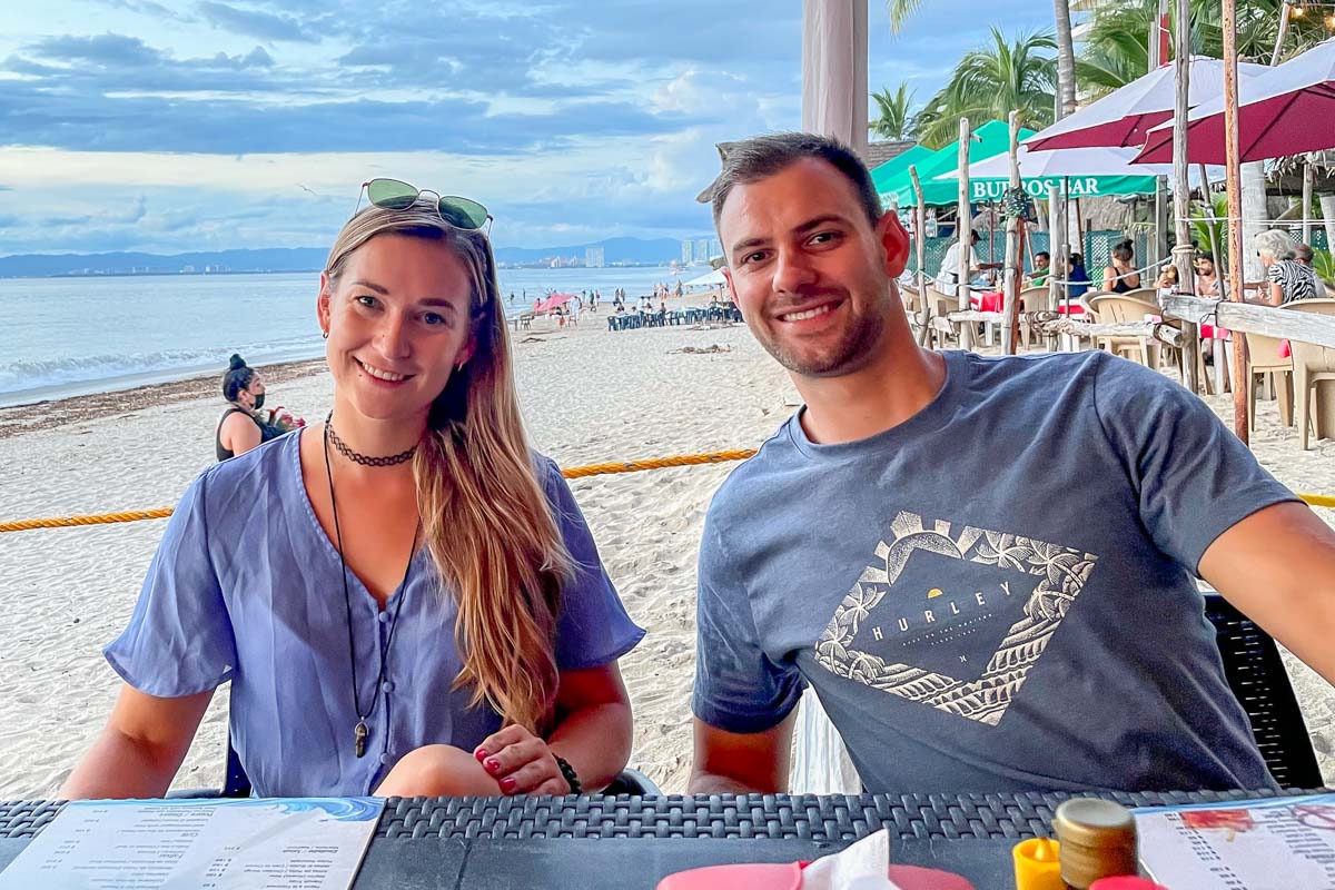 Bailey and Daniel from Destinationless Travel at a restaurant in Mexico