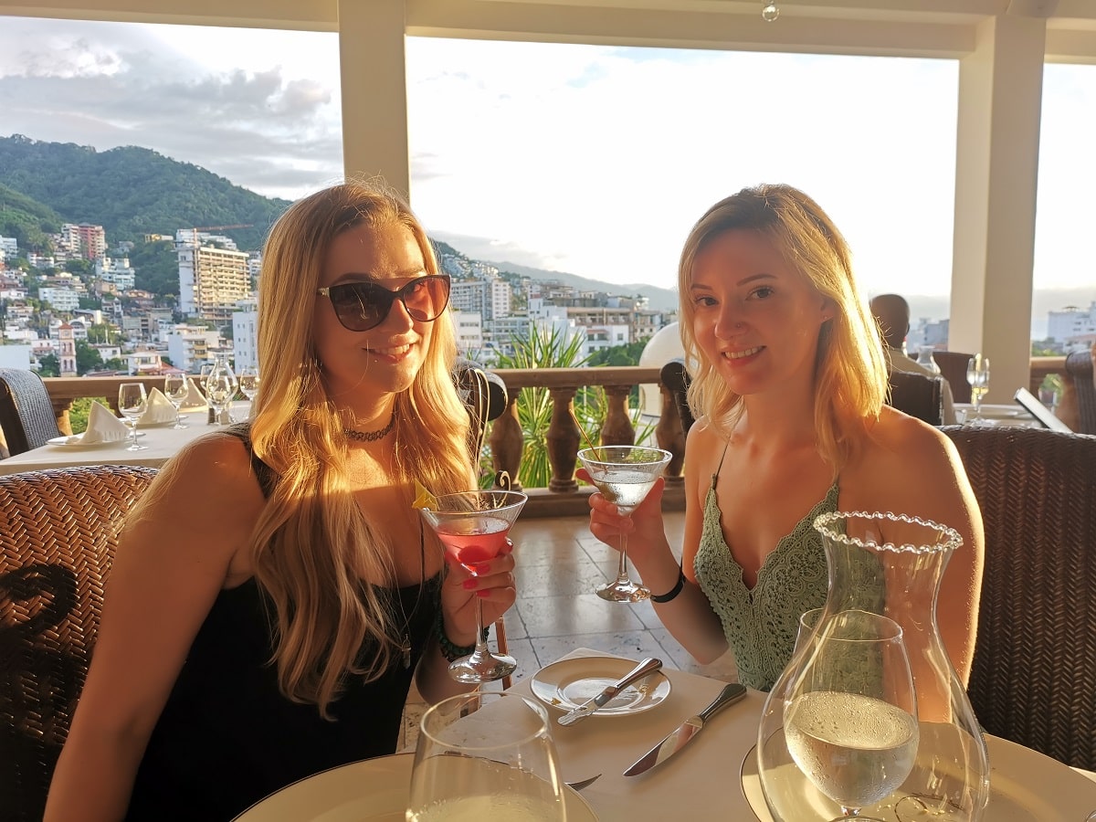 two women sitting in La Iguana Restaurant in Puerto Vallarta with a view of the city