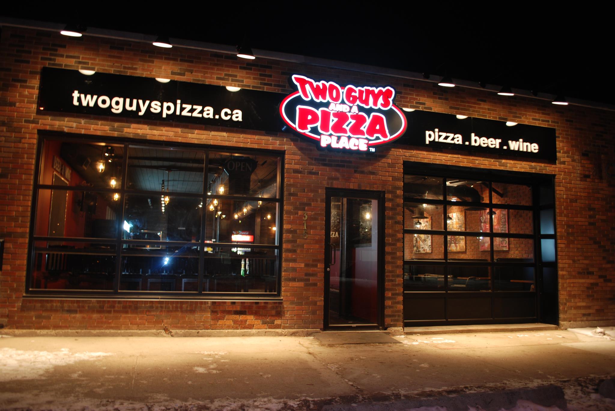 the outside of two guys and a pizza place restaurant in Lethbridge, Alberta