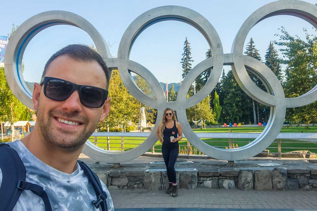 Bailey and Daniel take a photo with the Olympic rings in Whistler, BC
