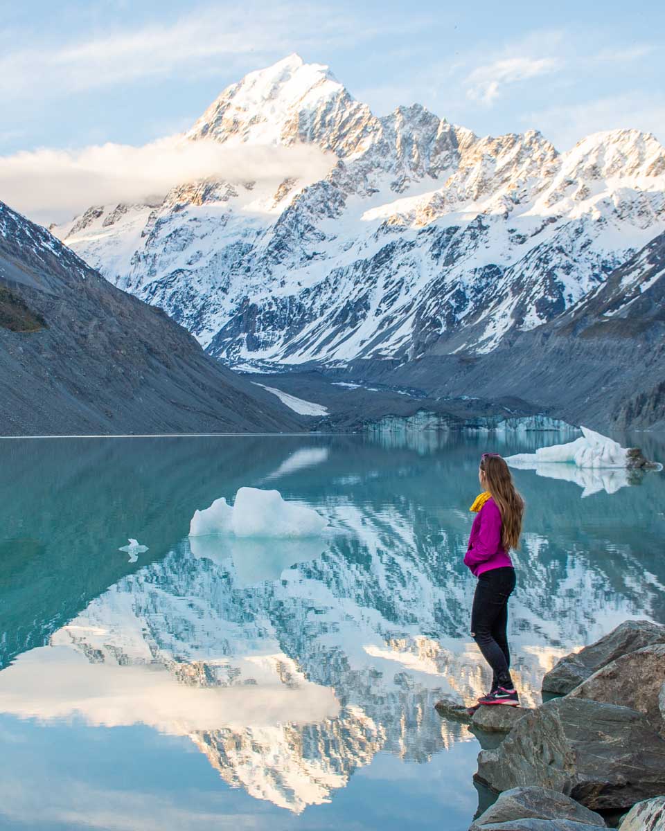 Bailey stands on the edge of the Hooker Lake in Mount Cook National Park