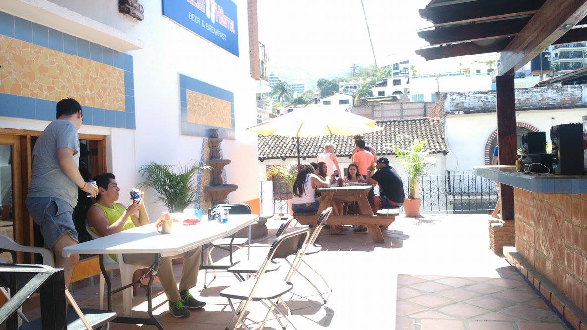 People relaxing in a common area at Chanclas Hostel Vallarta