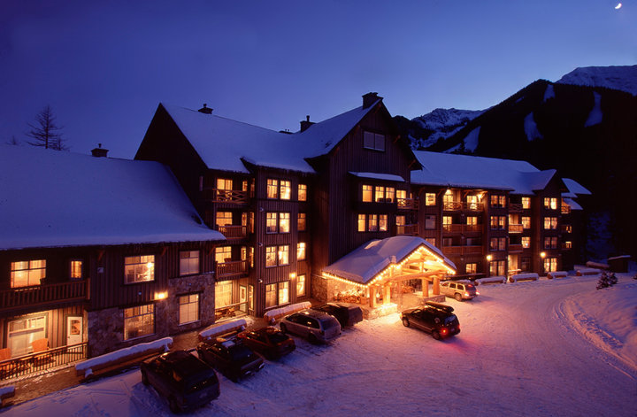 Snow Creek Lodge by Fernie Lodging Co covered in snow at night