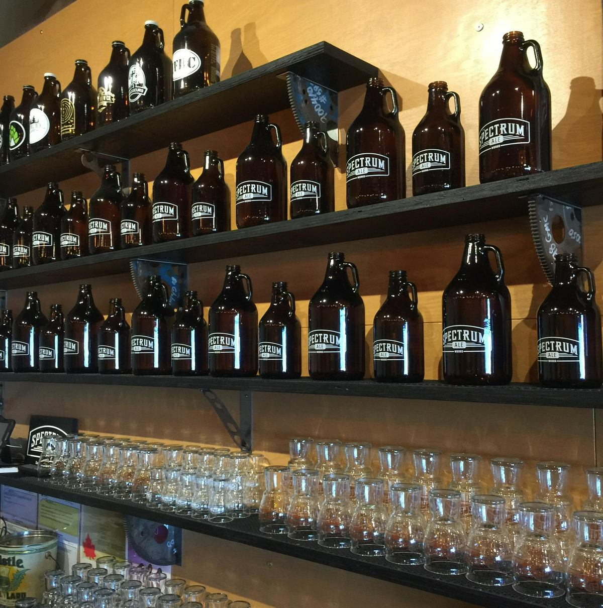 Spectrum Ale Works growler and glass wall