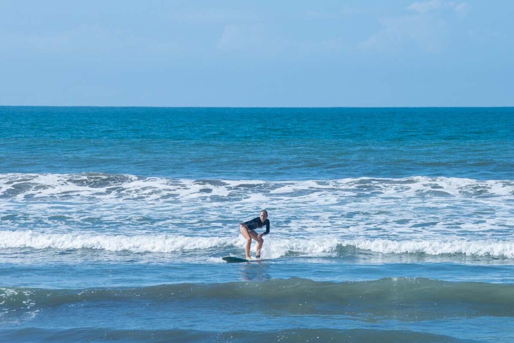 A lady learns to surf in Jaco, Costa Rica