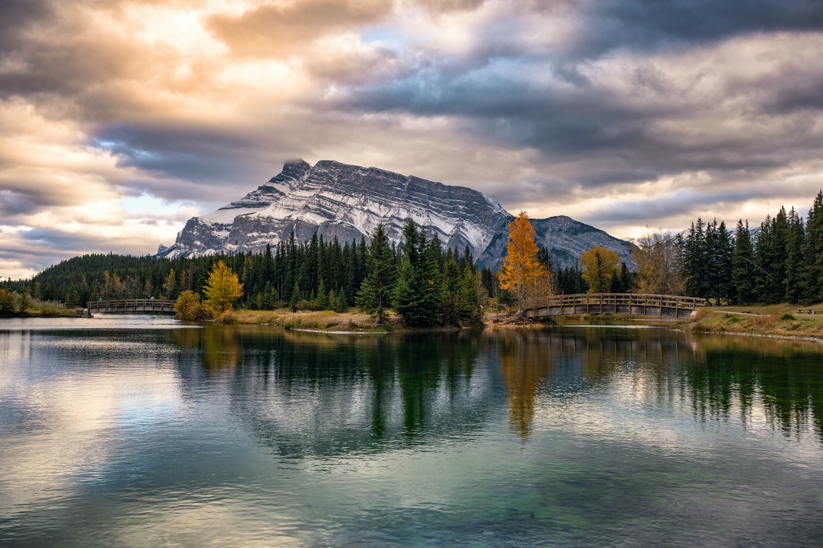 Cascade Ponds with mount rundle and wooden bridge in autumn forest