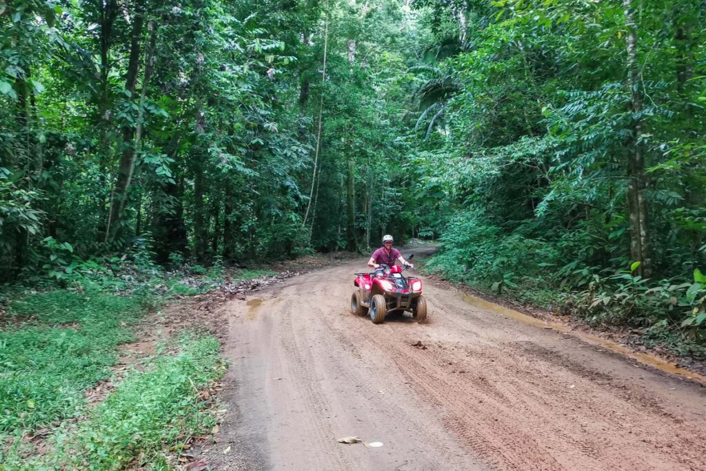 A man rides an ATV through the jungle near Drake Bay