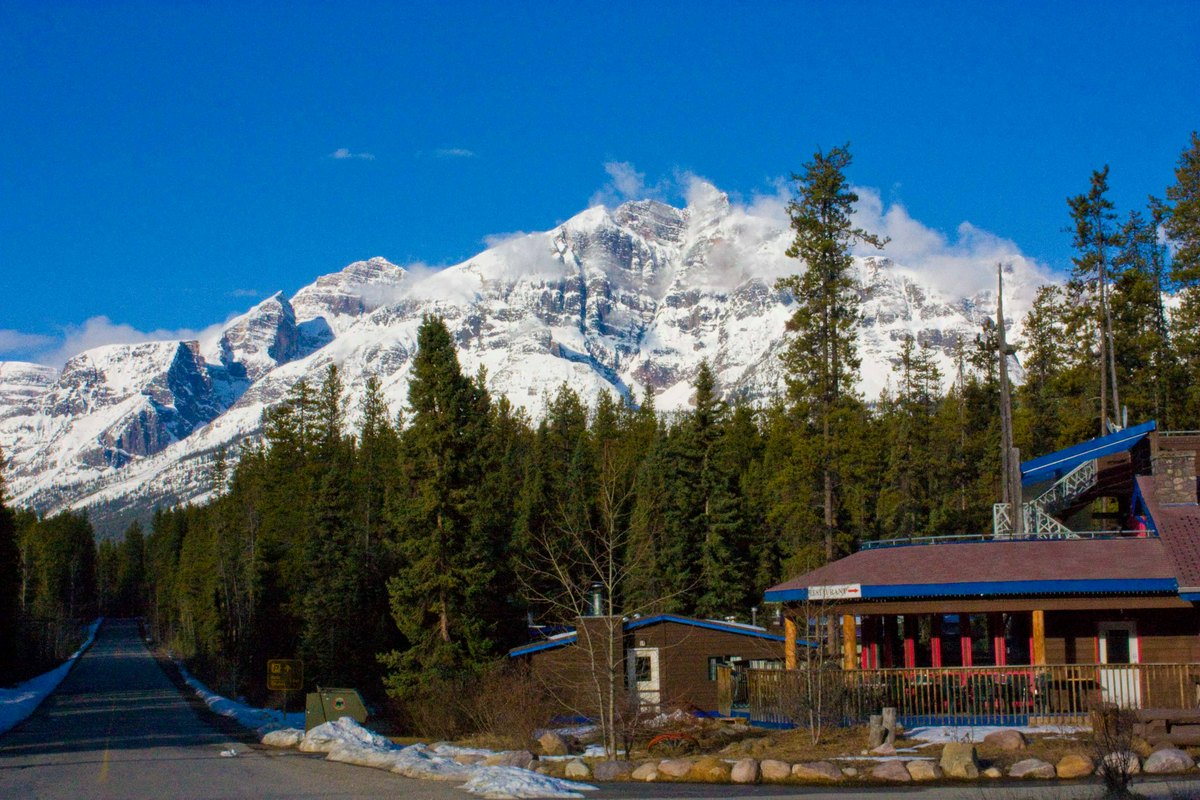Views of the snow covered Rocky Mountains in the back of Sunwapta Falls Rocky Mountain Lodge.