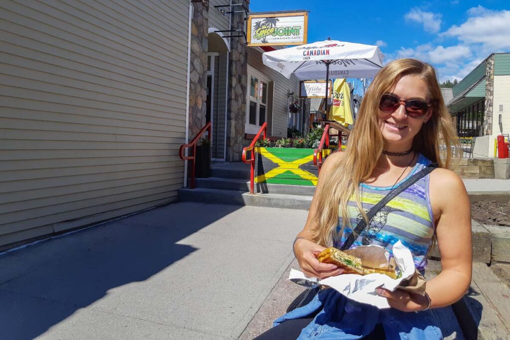 A lady eats a sandwich in Jasper town