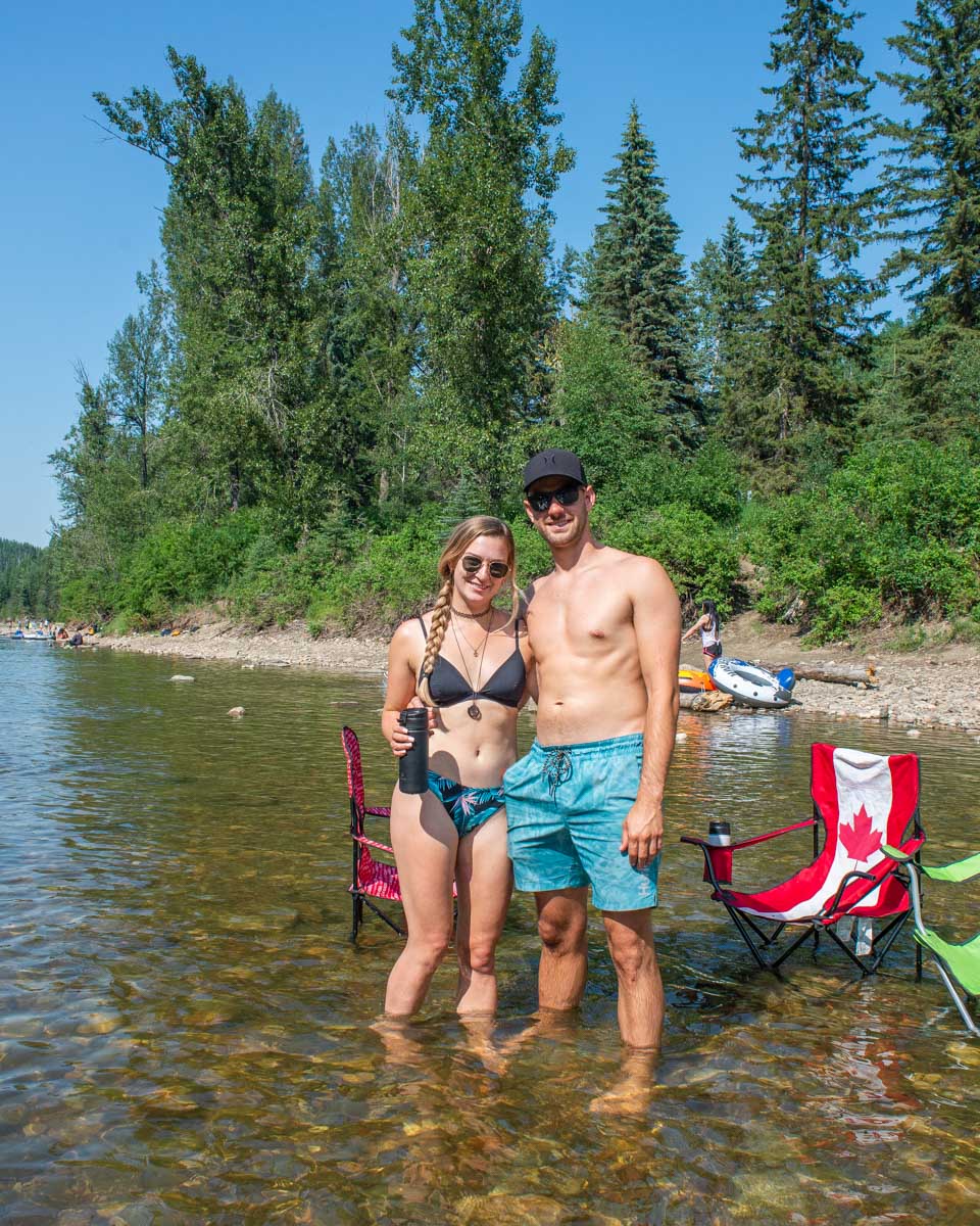 Bailey and Daniel wade in the water at Pembina River