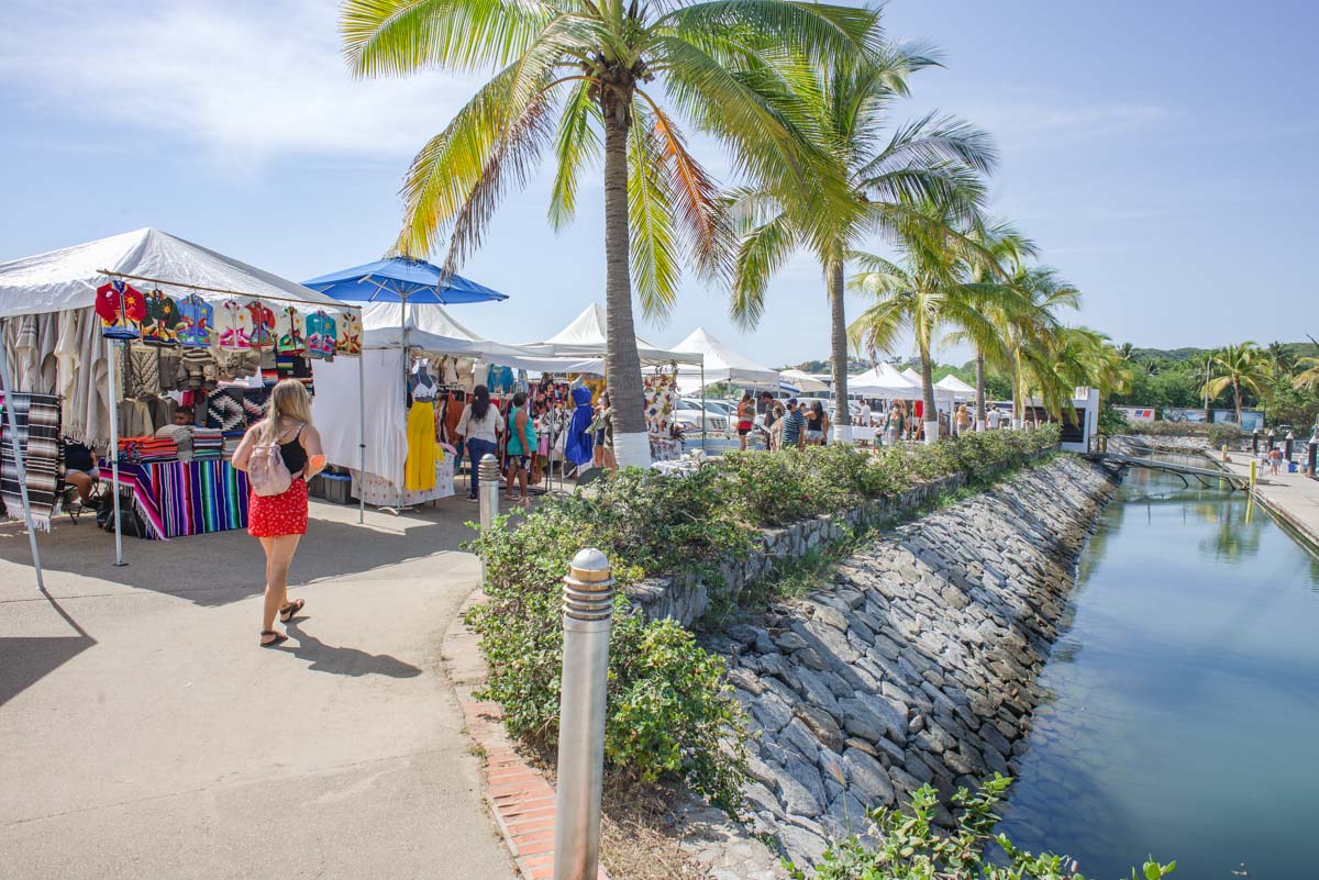 woman walks in the Santa Cruz Market - one of the best day trips fom Puerto Vallarta