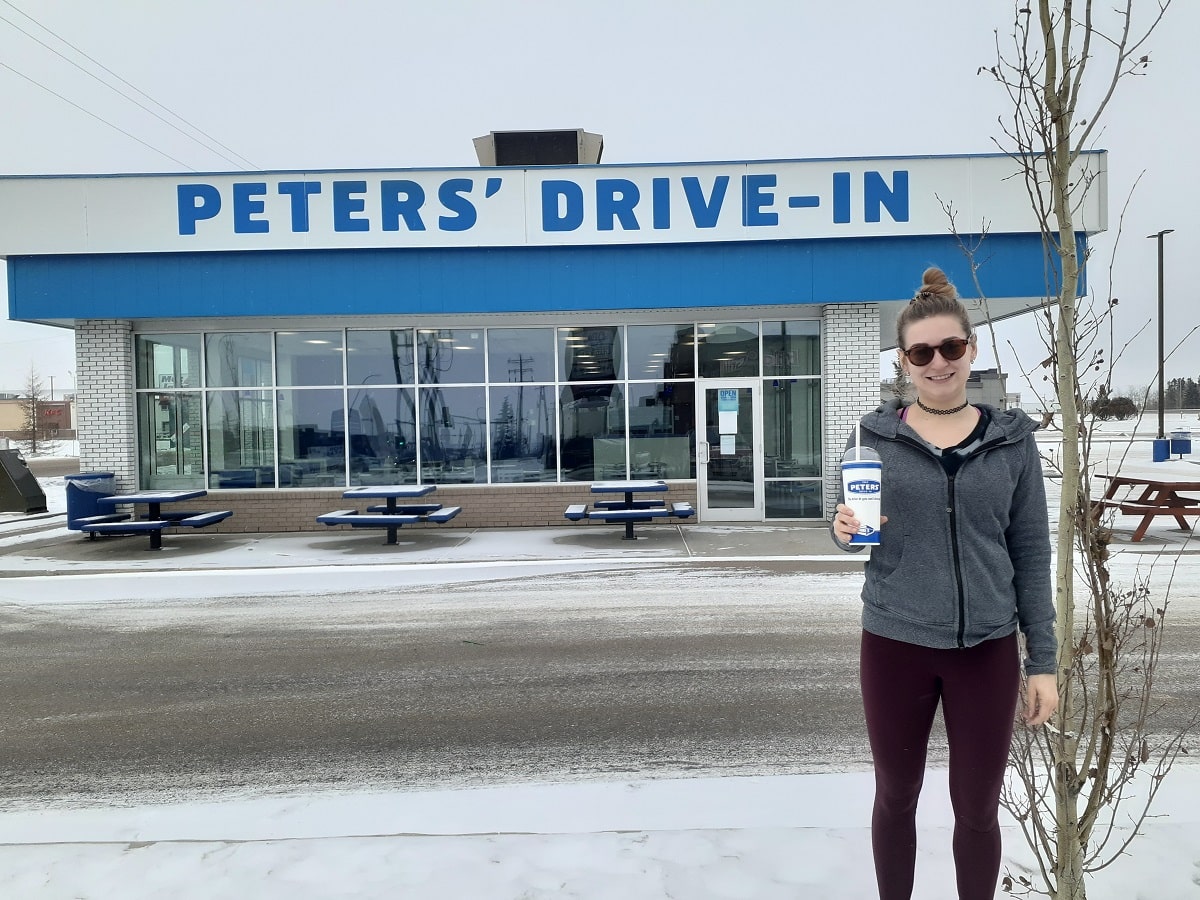 woman stand outside of Peters Drive in on Gasoline Alley
