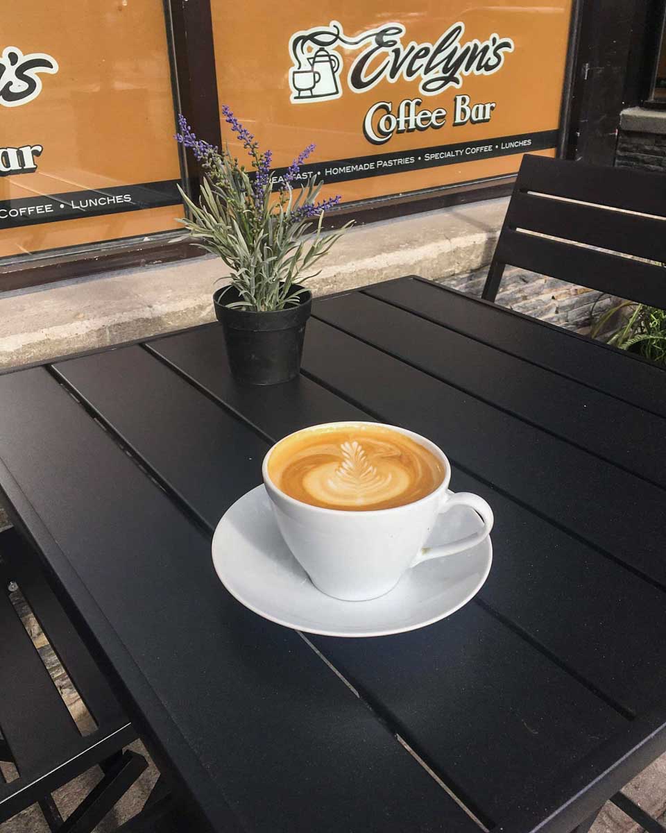 A coffee on a table at Evelyns Coffee Bar