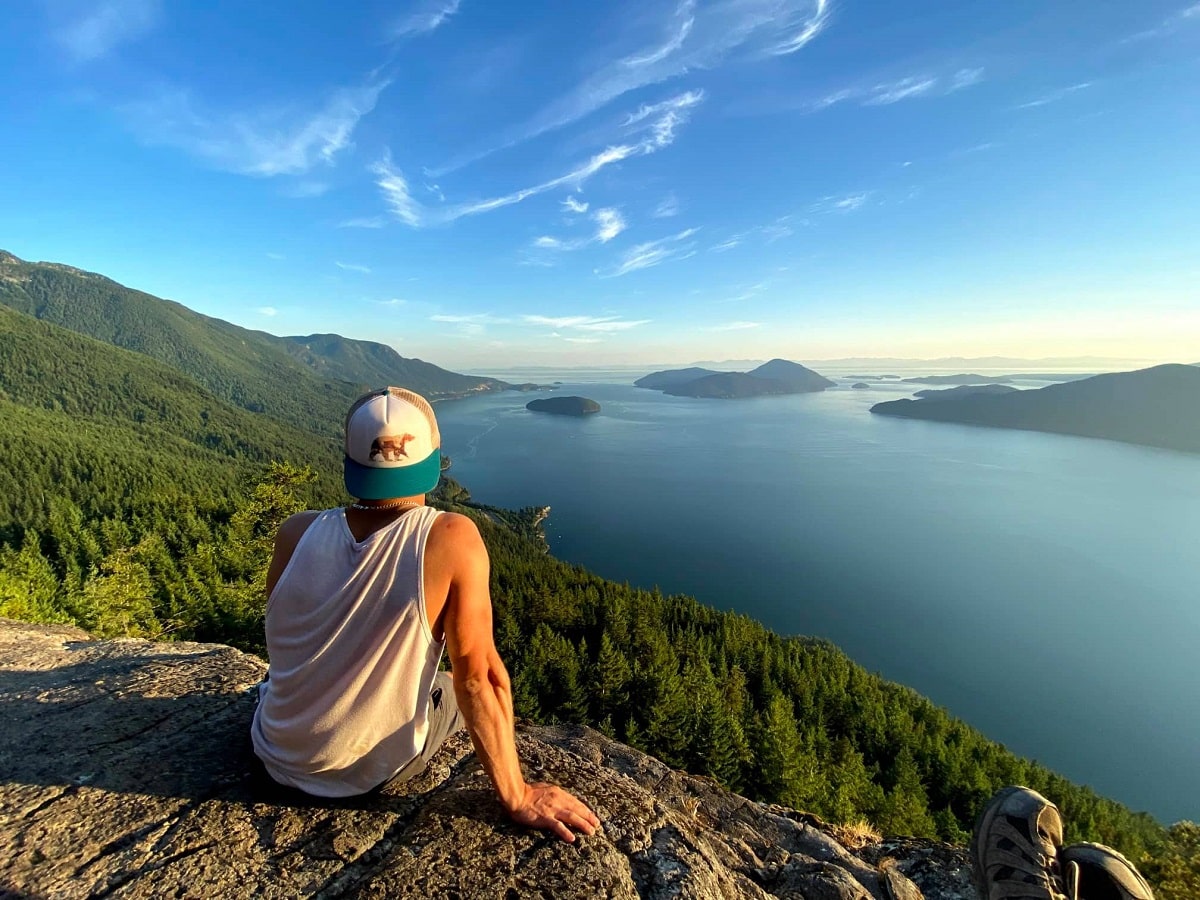 man sitting at the top of Tunnel Bluffs Hike