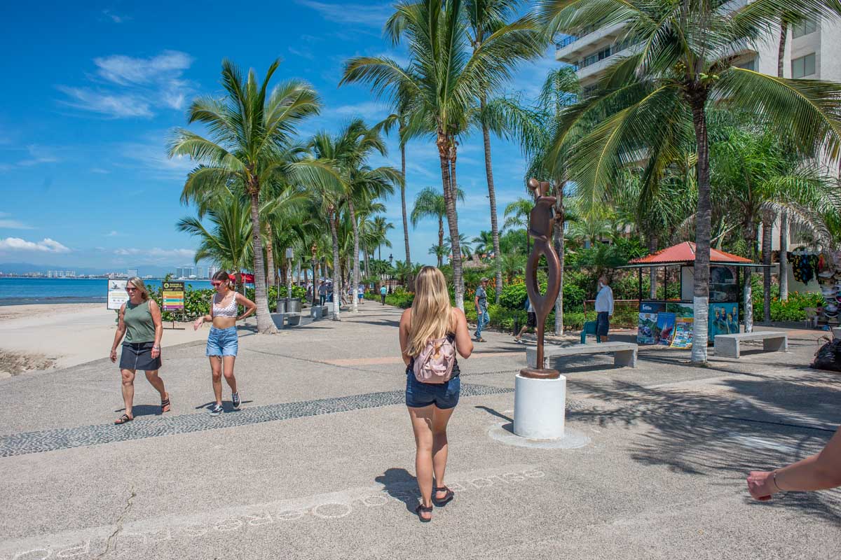 A lady walks along the southern end of the Puerto Vallarta Malecon