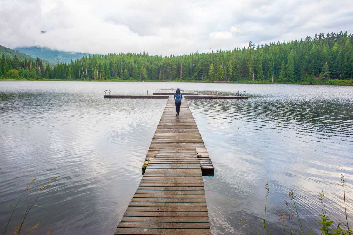 Lady walks on a dock in Whistler