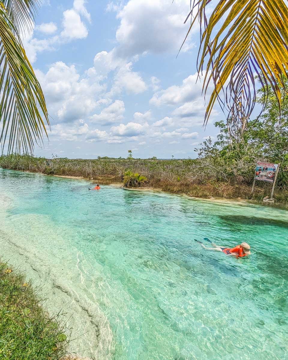 A lady floats down Los Rapidos de Bacalar in Bacalar, Mexico