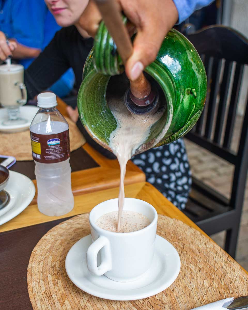 A man pours a traditional hot chocolate in Oaxaca, Mexico