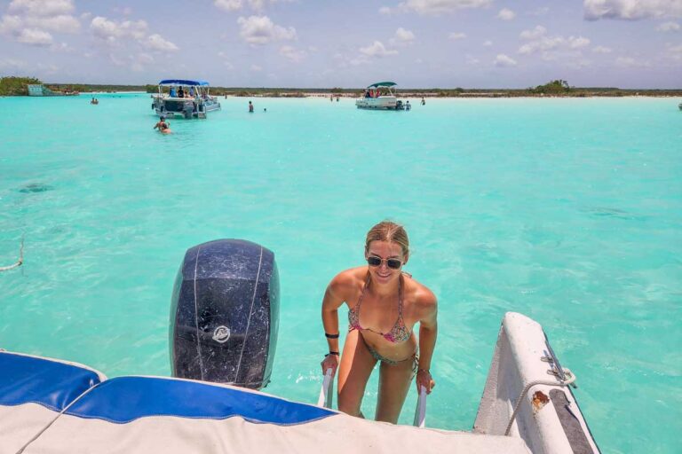 Bailey climbs onto the boat in Bacalar Lagoon