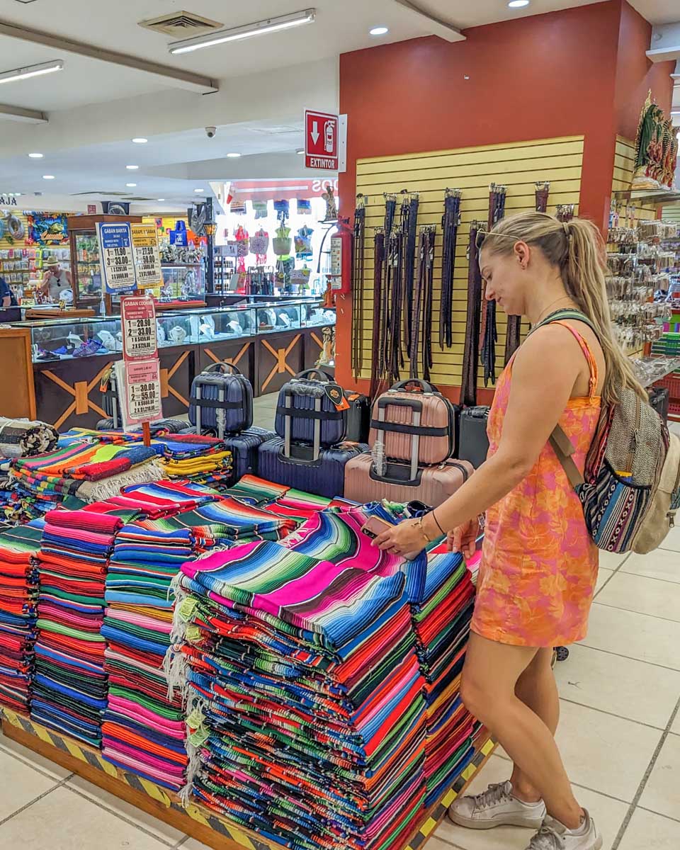 Bailey looks at traditional Mexican blankets in the La Isla Shopping Mall in Cancun, Mexico