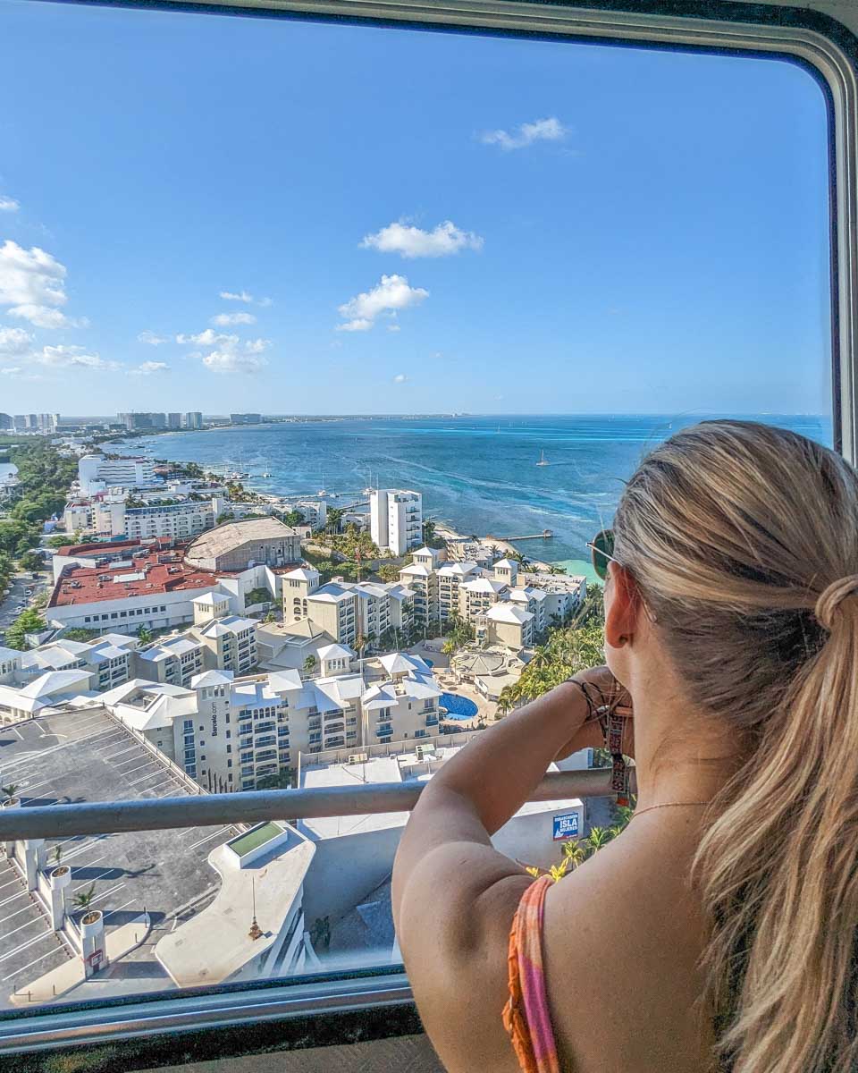 Bailey looks out the window of the Cancun Scenic Tower in Cancun, Mexico