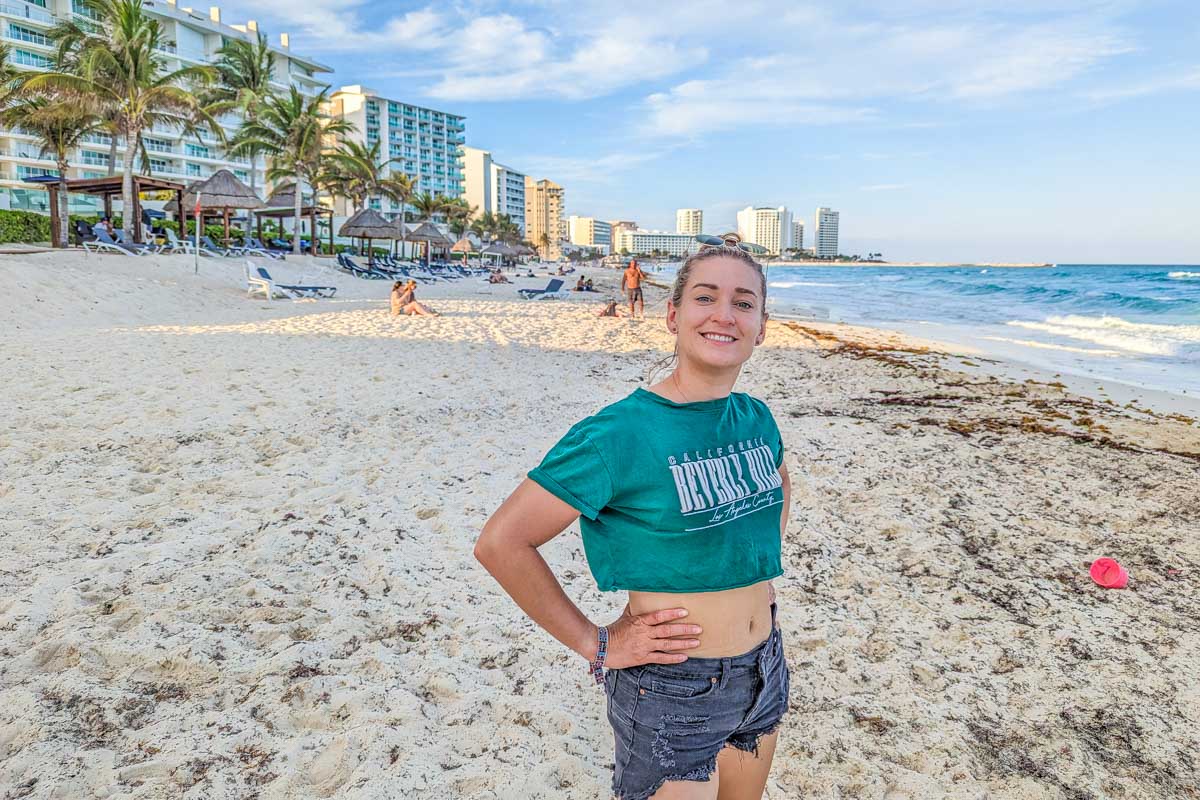 Bailey poses for a photo on a beach in Cancun