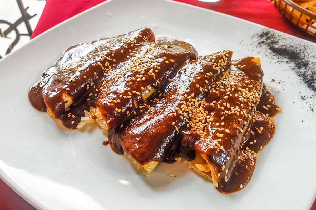 Mole sauce poured over tacos in Oaxaca, Mexico