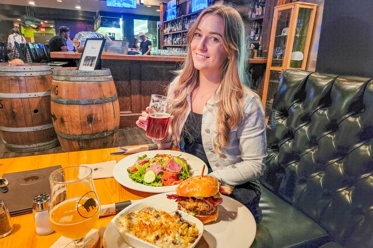 Bailey drinks craft beer with food at Noble Pig Brewing