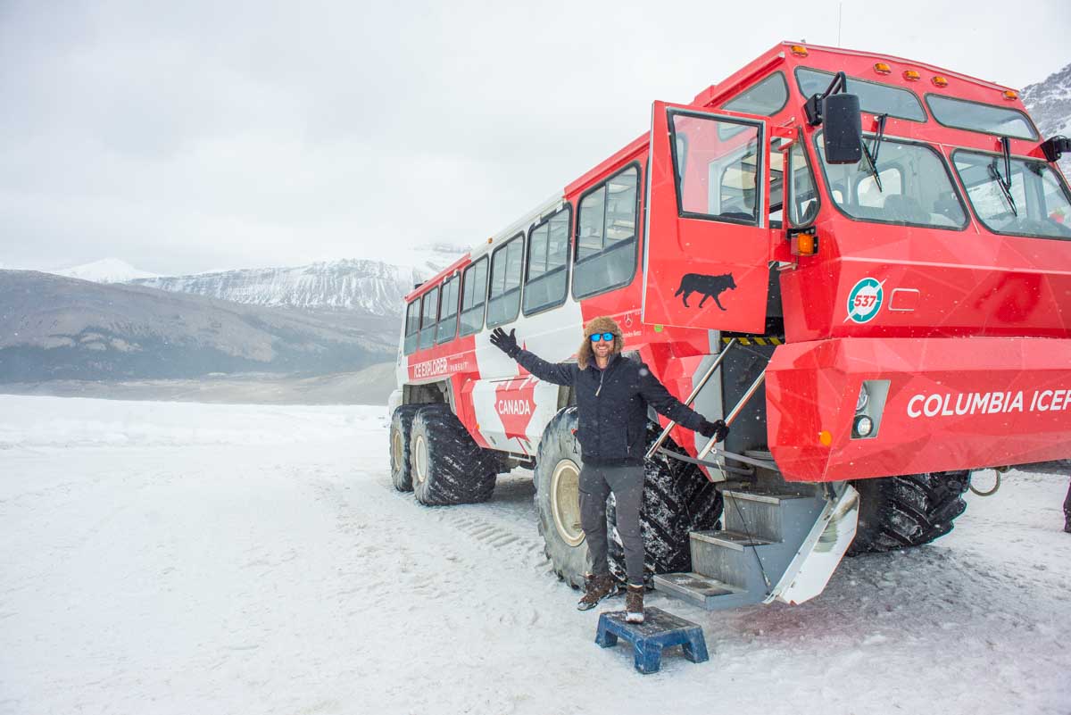 Daniel hangs out the door of an Ice Explorer all-terrain vehicle on the Athabasca Glacier in the Columbia Icefield, Canada