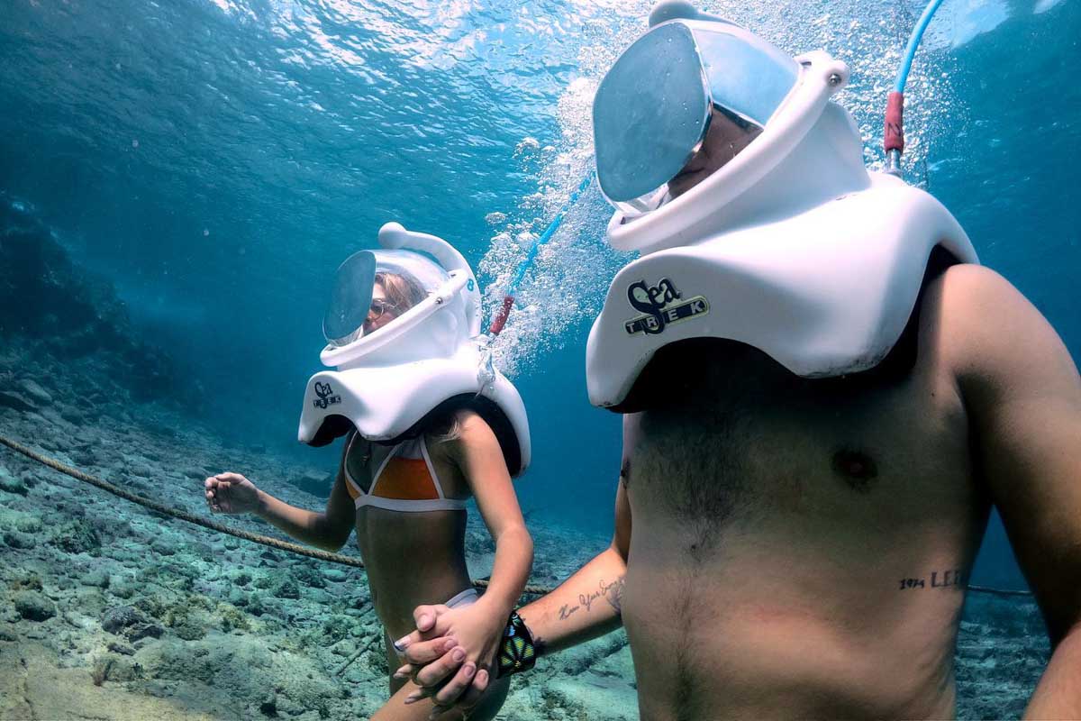 Two people on an underwater helmet trek in Cozumel, Mexico