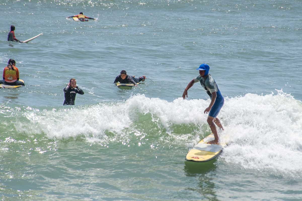 A man surfs on the beach in Lima, Peru