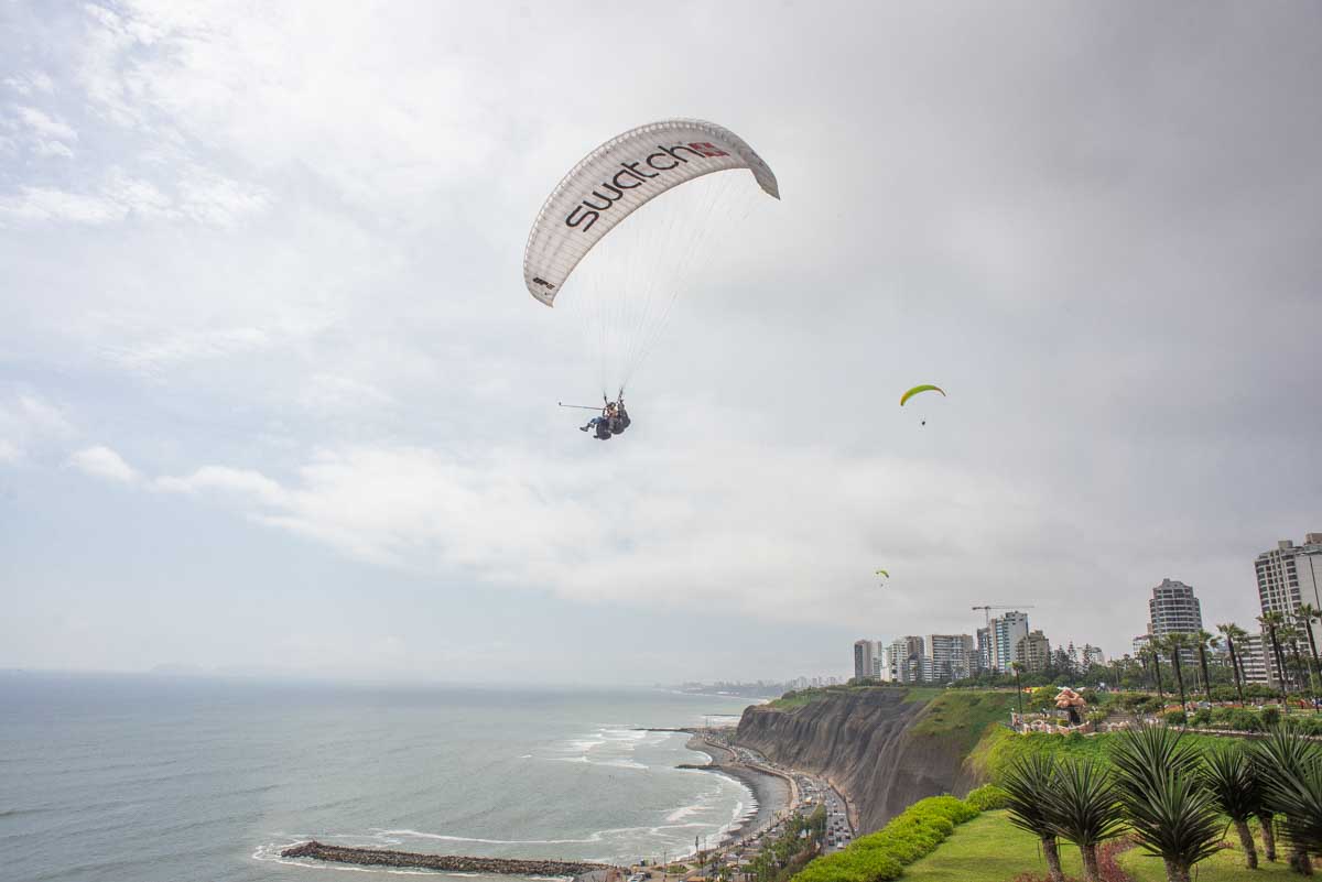 A person paragliding on the cliffs in Lima, Peru