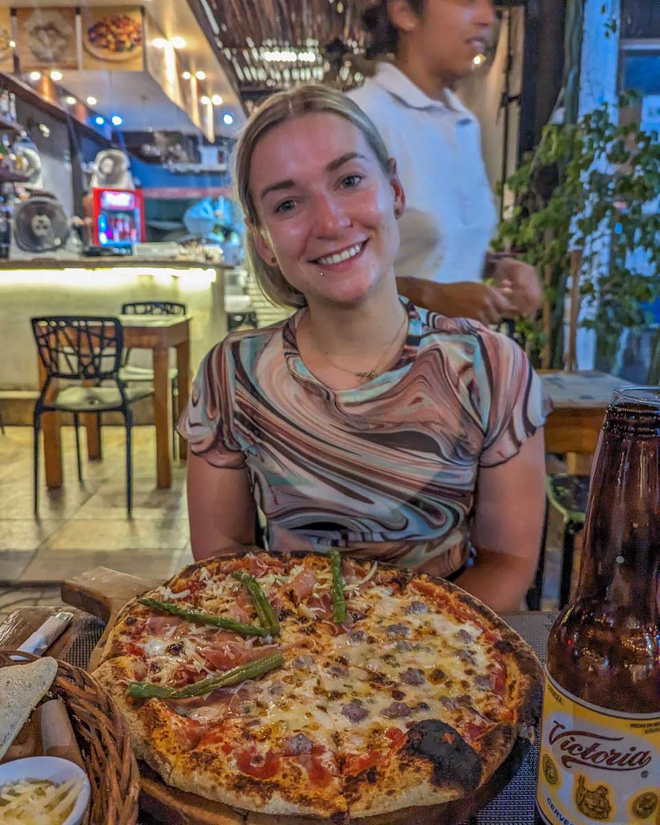 Bailey with her pizza from Capricci Pizza & Sfizi on Isla Mujeres