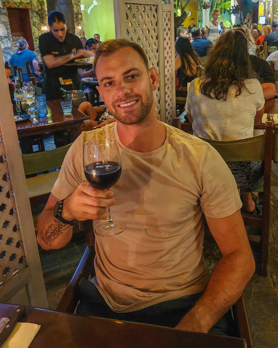Daniel enjoys a glass of wine at Guido's on Cozumel, Mexico