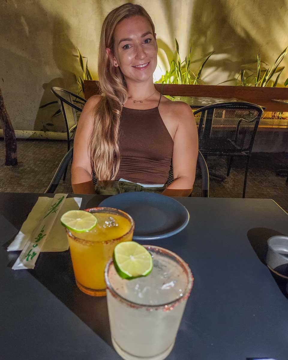 Bailey with her cocktails at Akuma Tiger in Tulum, Mexico