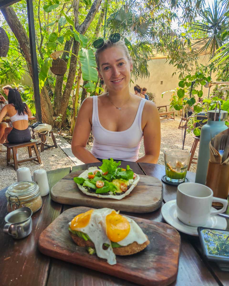 Bailey with her meal at Botanica Garden Cafe in Tulum, Mexico