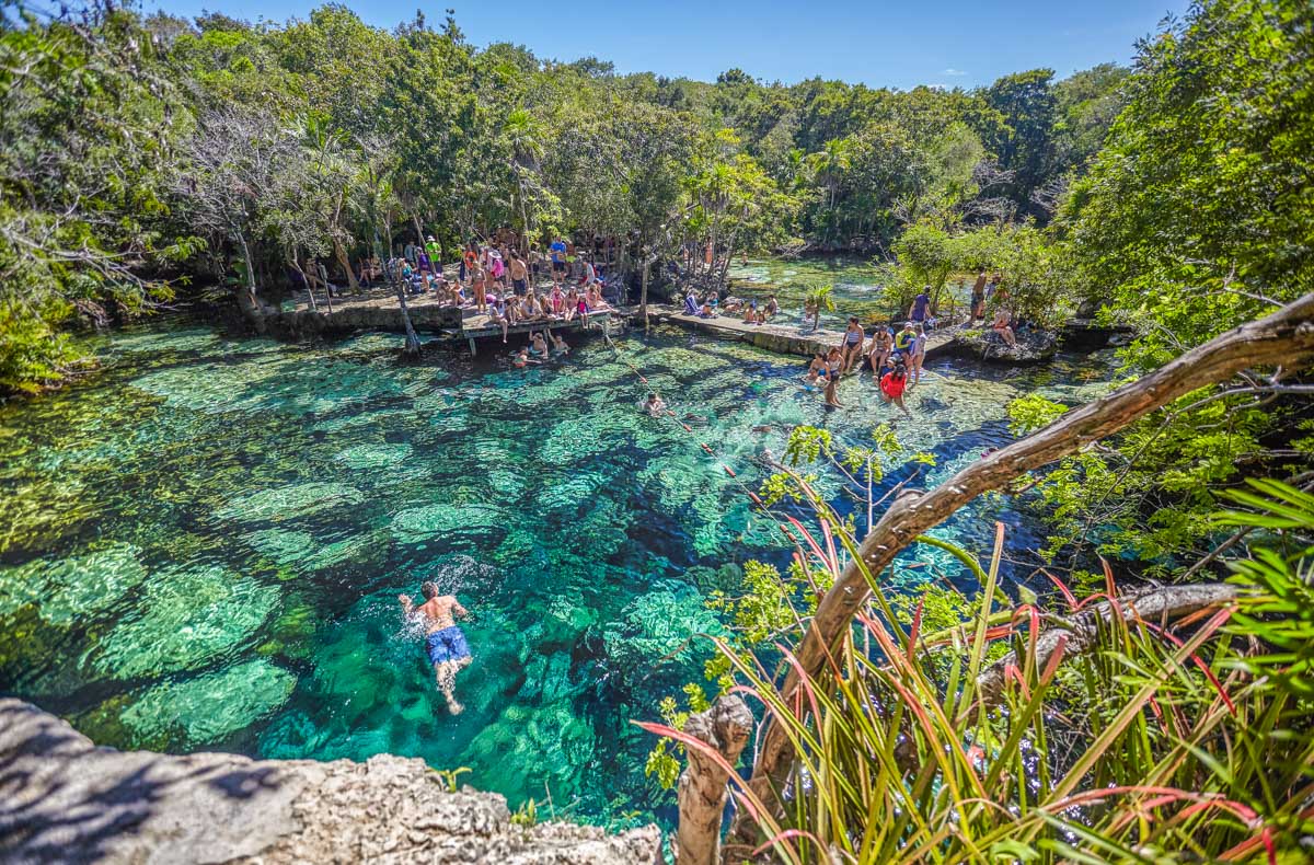 A man swims in Cenote Azul, Mexico