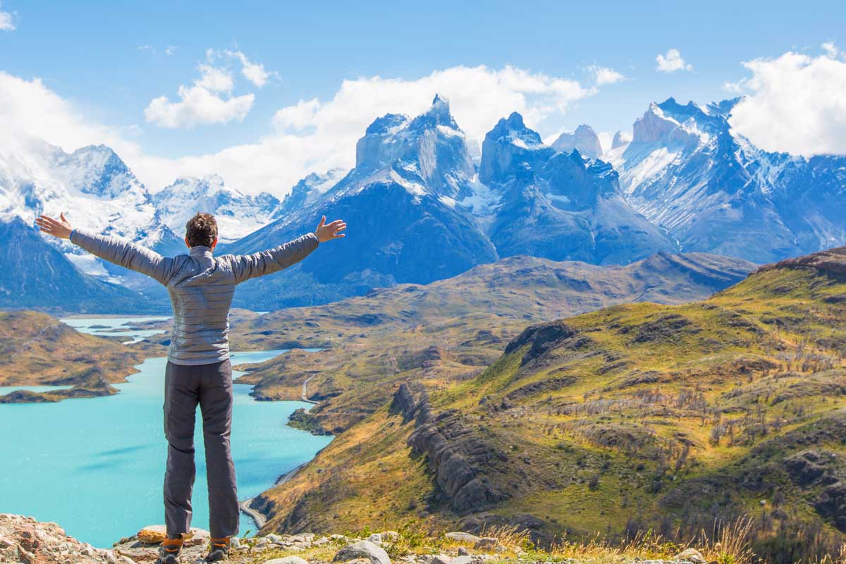 A man stands at Mirador Condor in torres del Paine National Park